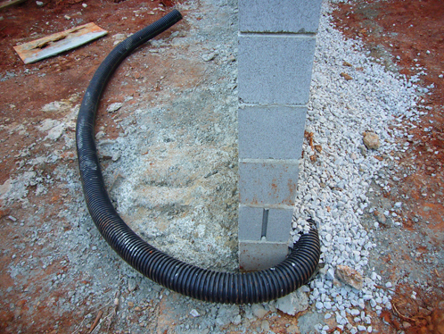 Plastic tubing for the french drain (or freedom drain if you're so inclined).